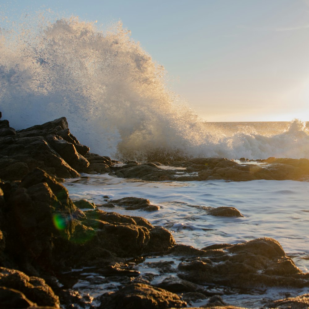 ocean waves crashing on rock formation