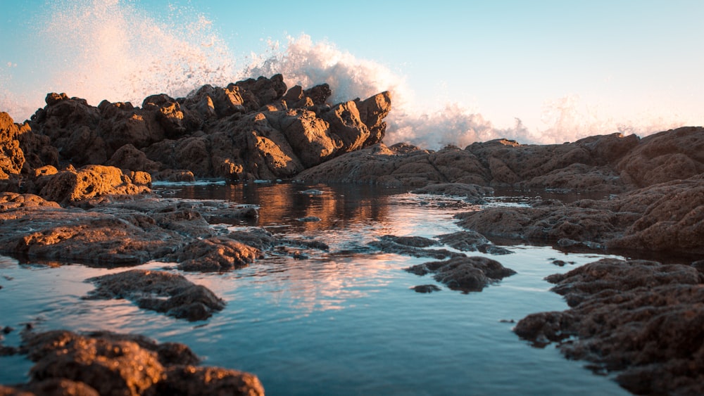 body of water surrounded by rock mountain