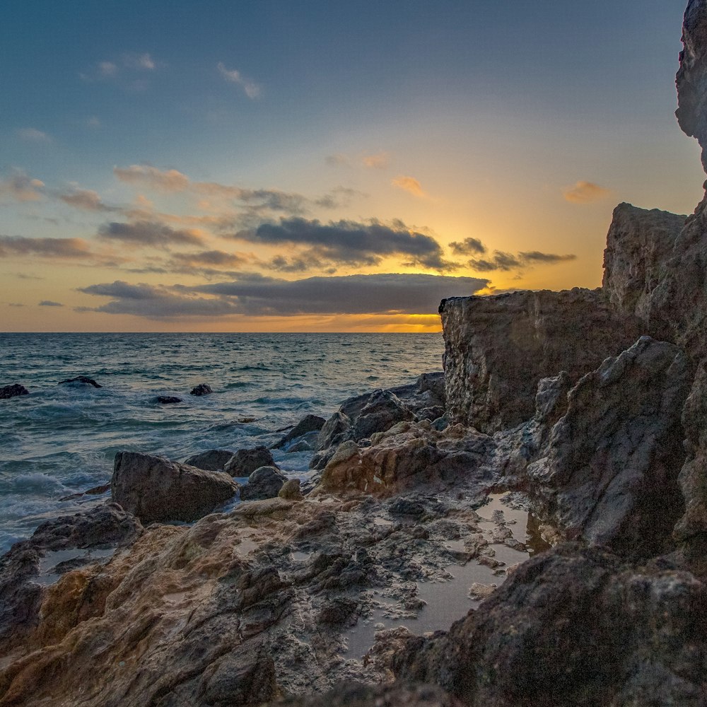 rocks beside body of water