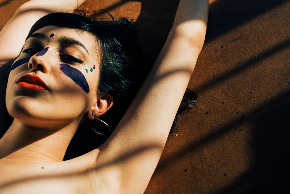 woman lying on brown concrete surface