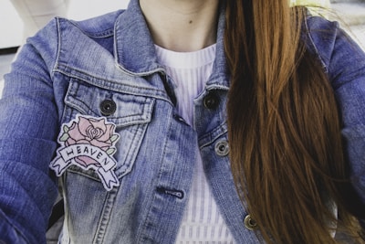 woman wearing blue denim faded jacket with patches