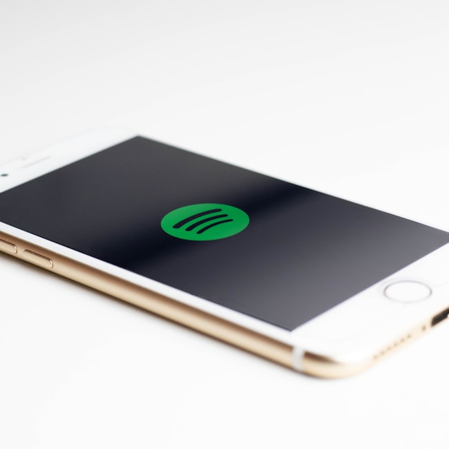 gold iPhone 7 displaying spotify logo