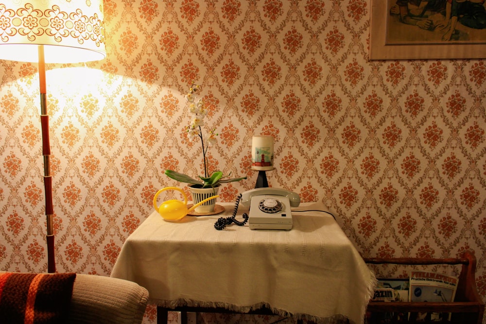 white rotary telephone on table