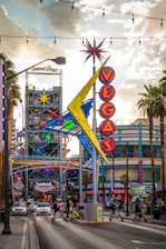 A vibrant Las Vegas street scene with an ebike rider cruising past neon lights.
