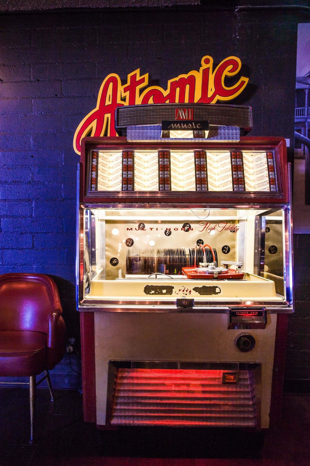 lighted brown and white arcade game console near wall