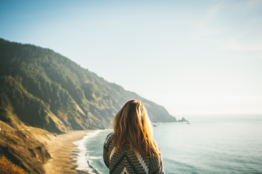 woman standing in front of sea