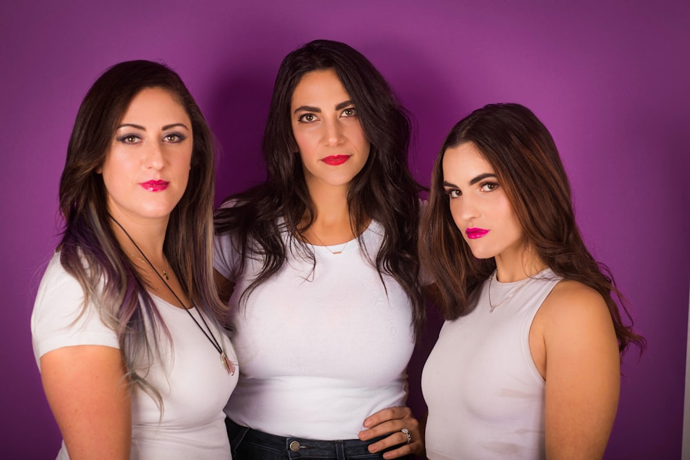 three women wearing white shirt