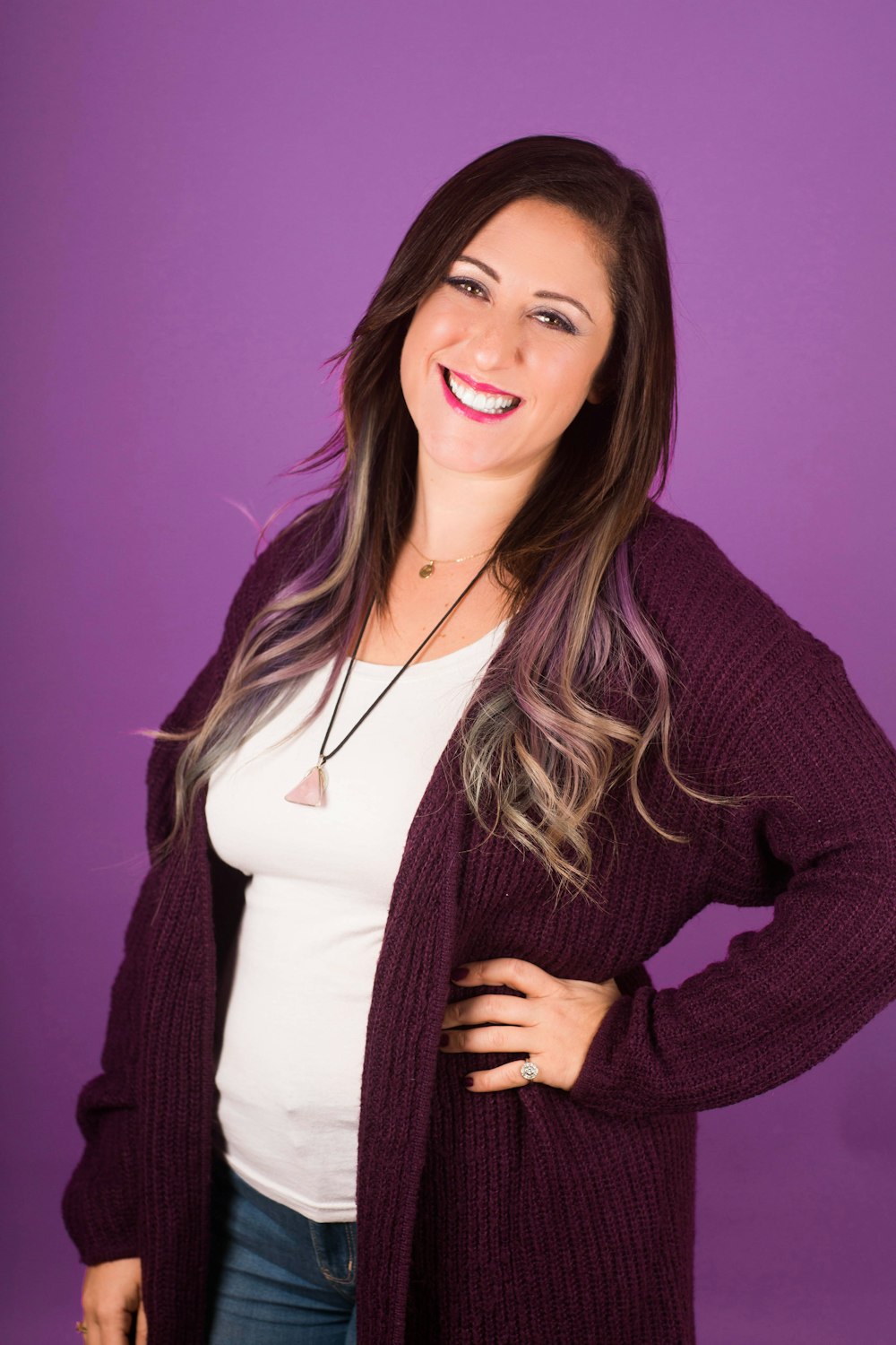 smiling woman in maroon blazer and white t-shirt