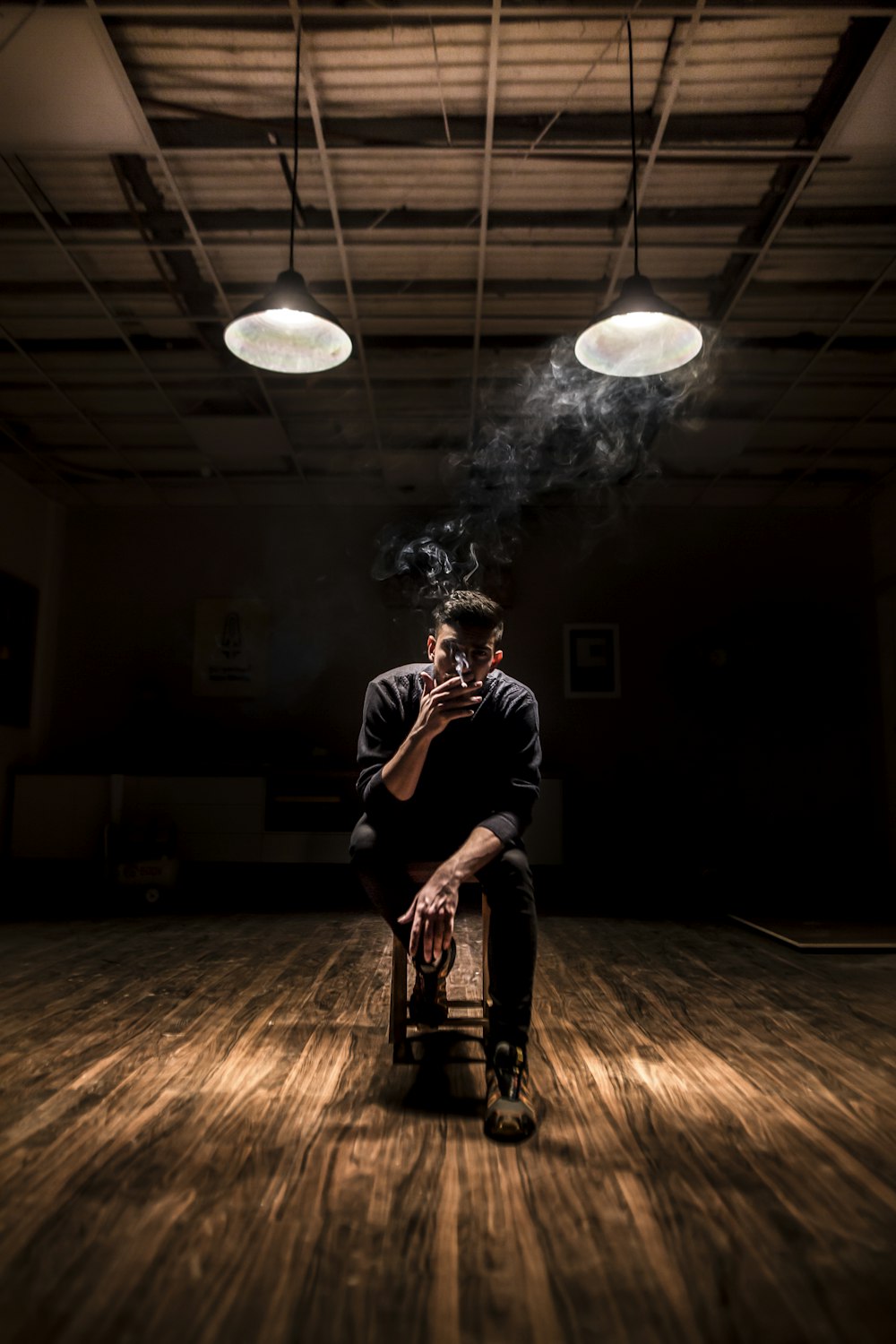 man sitting on chair while smoking