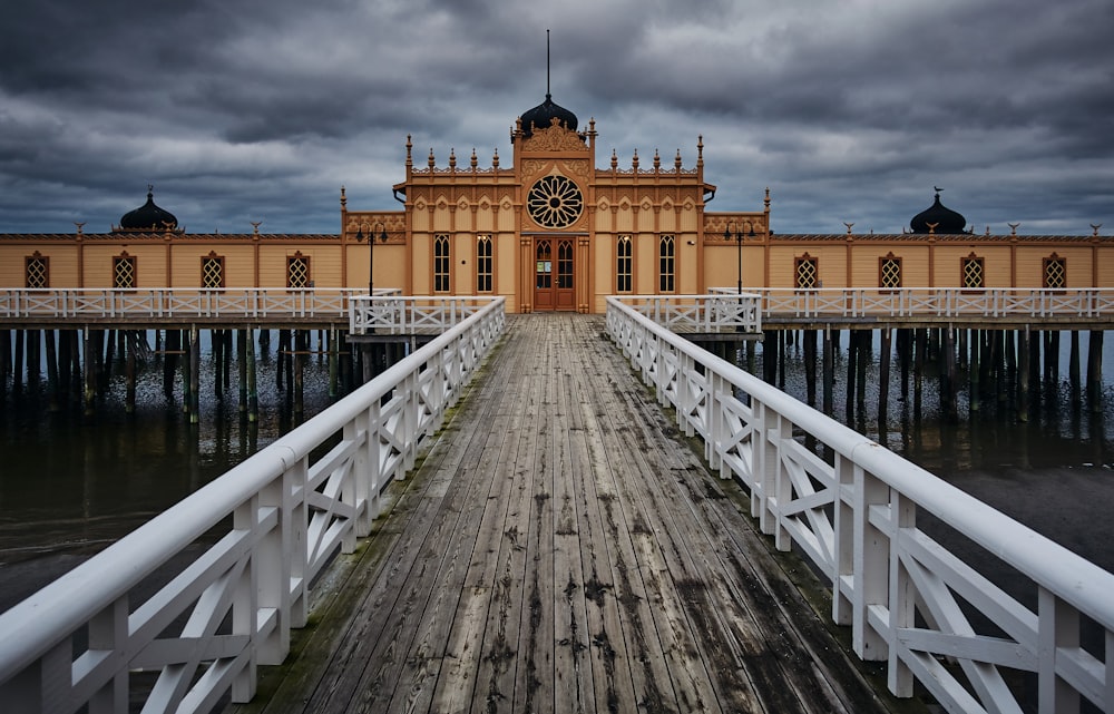 wooden pier in front of beige building