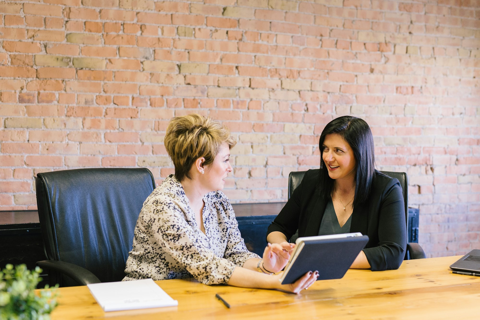 Working mom sat at table talking with mentor