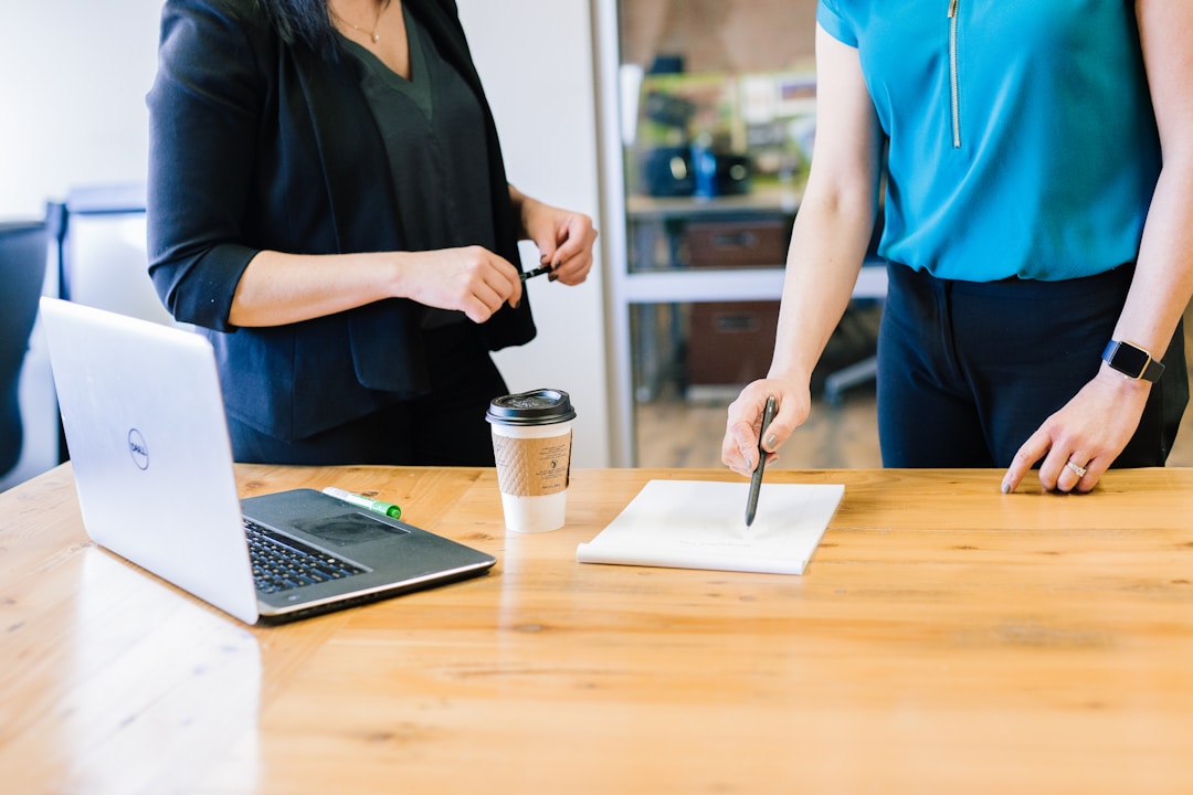 Two professionals discuss effective knowledge management systems' essential features and functions in a modern workplace setting.