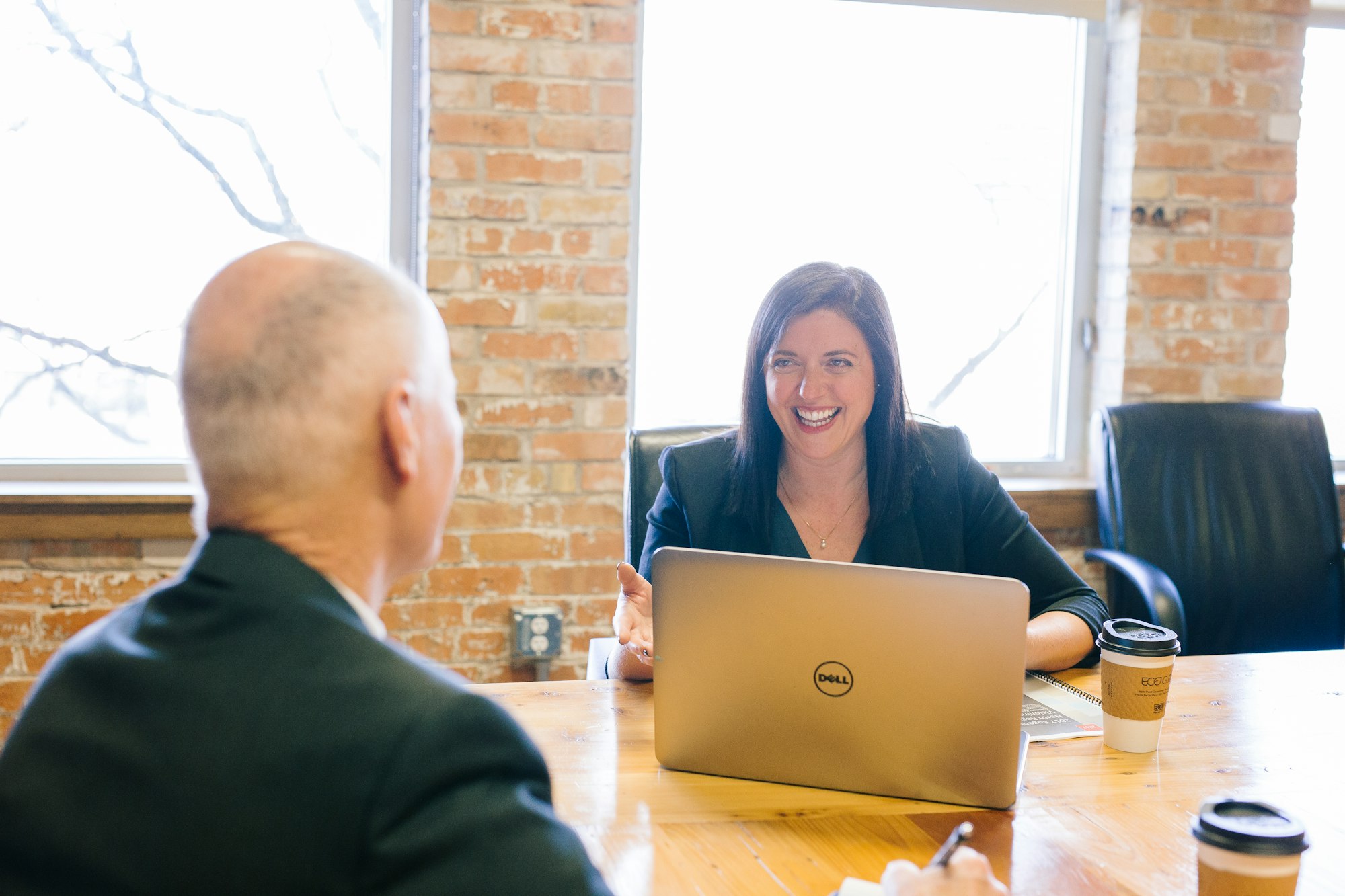 Working mom talking smiling and talking with colleague