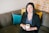 woman holding cup of coffee sitting on sofa