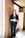 woman standing by wall holding mug