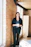 woman standing by wall holding mug
