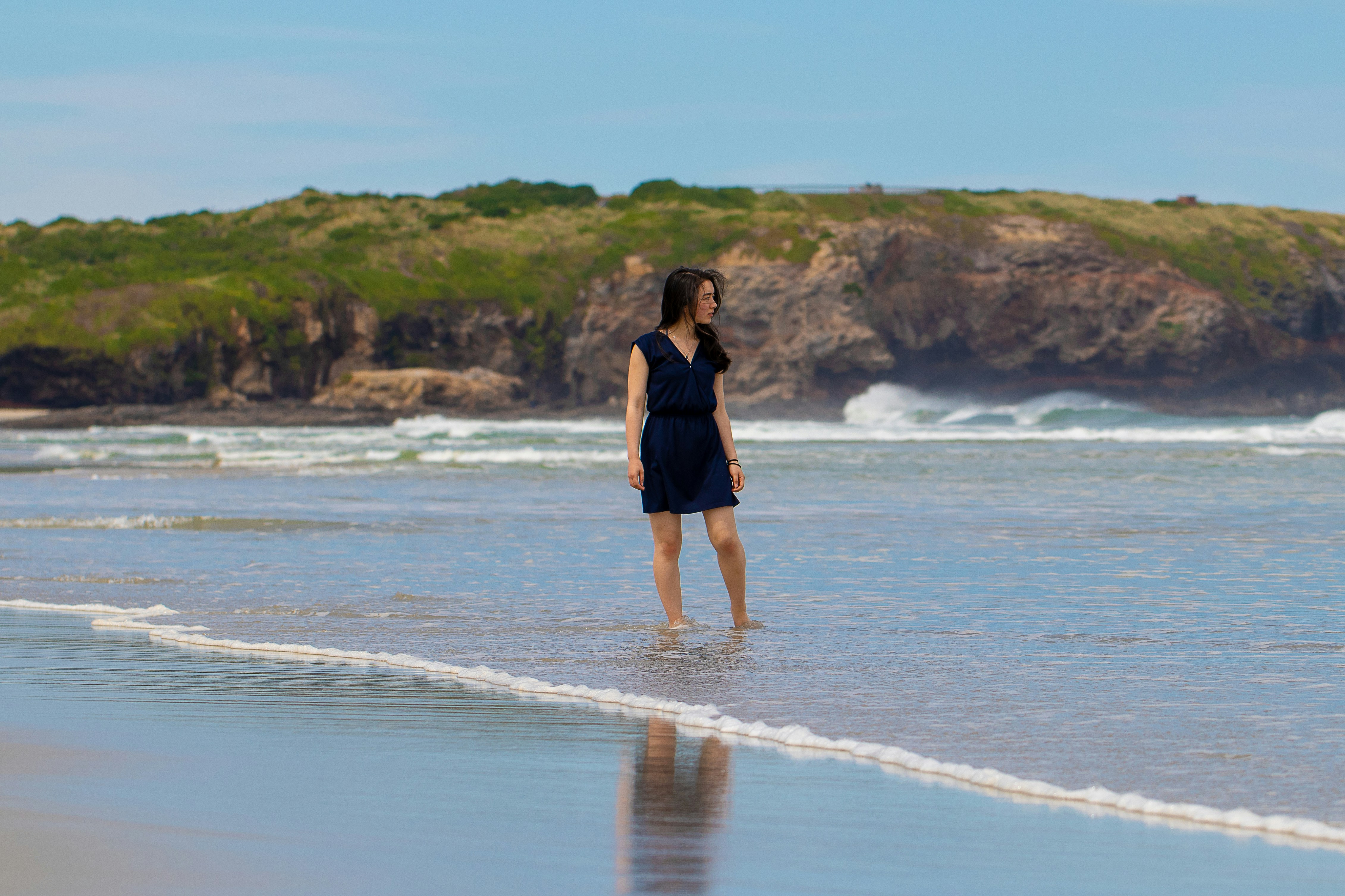 woman standing near body of water outstanding teams background