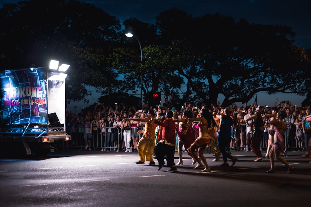 men dancing under spot light