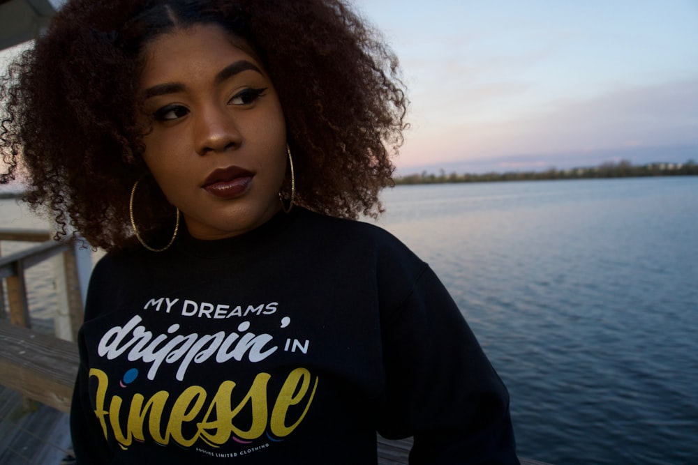 woman in black shirt near body of water