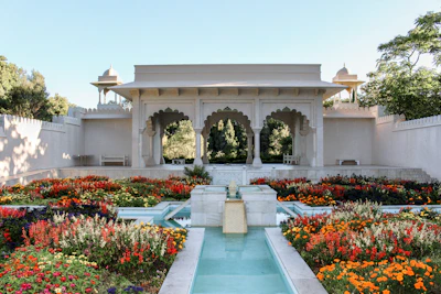 The vibrant Mughal Gardens in full bloom with colorful flowers and fountains.