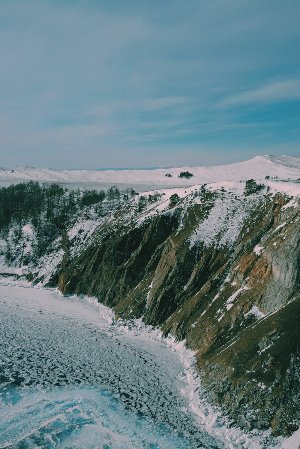 snow-covered mountain near ocean