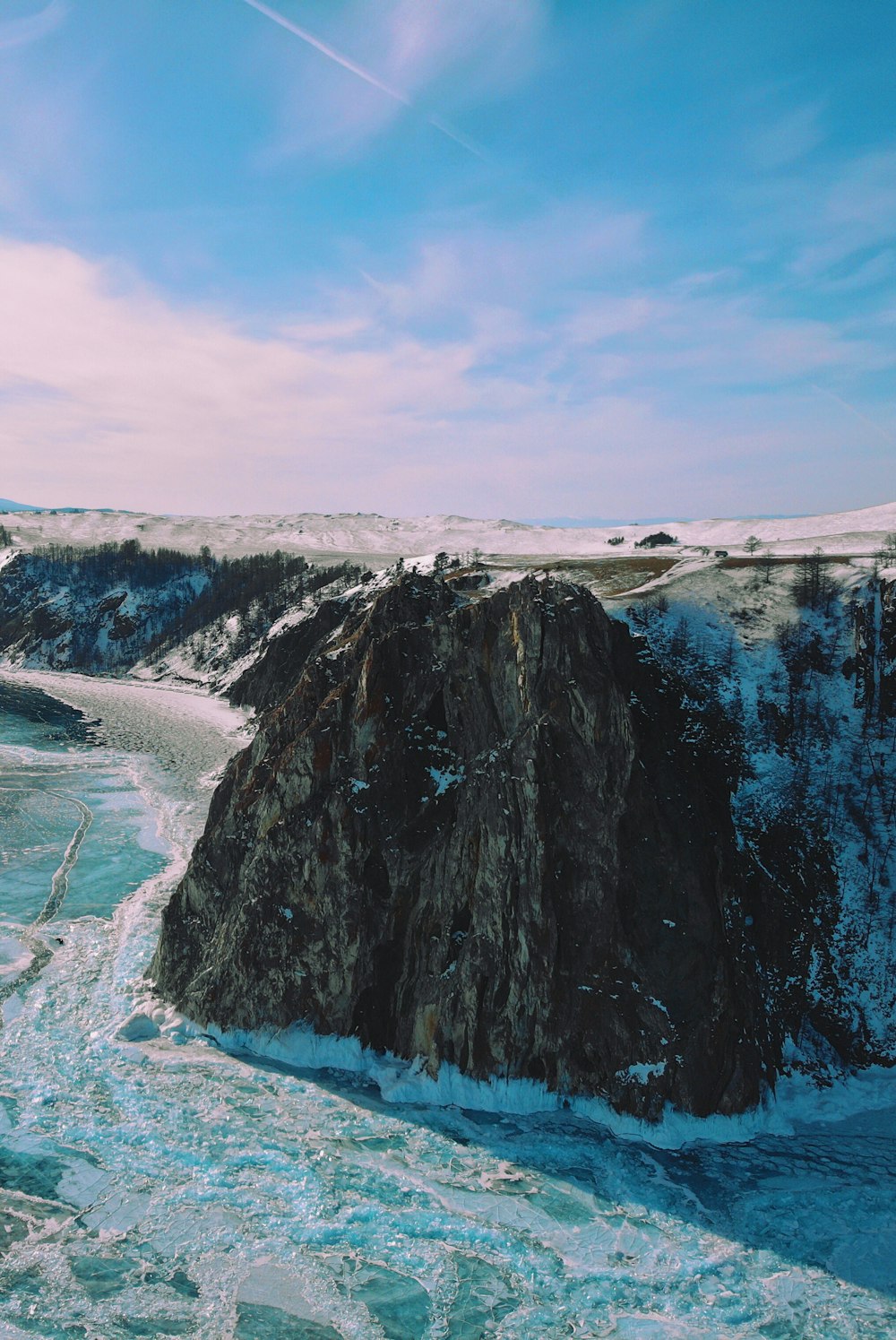 body of water near rock