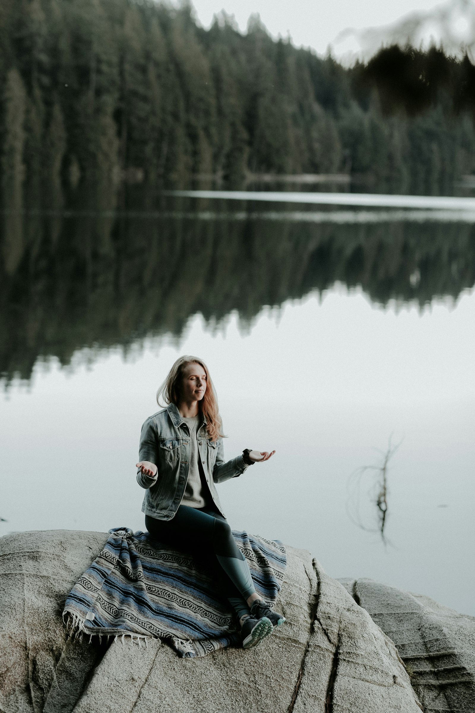 Canon EF 85mm F1.4L IS USM sample photo. Woman meditating on rock photography