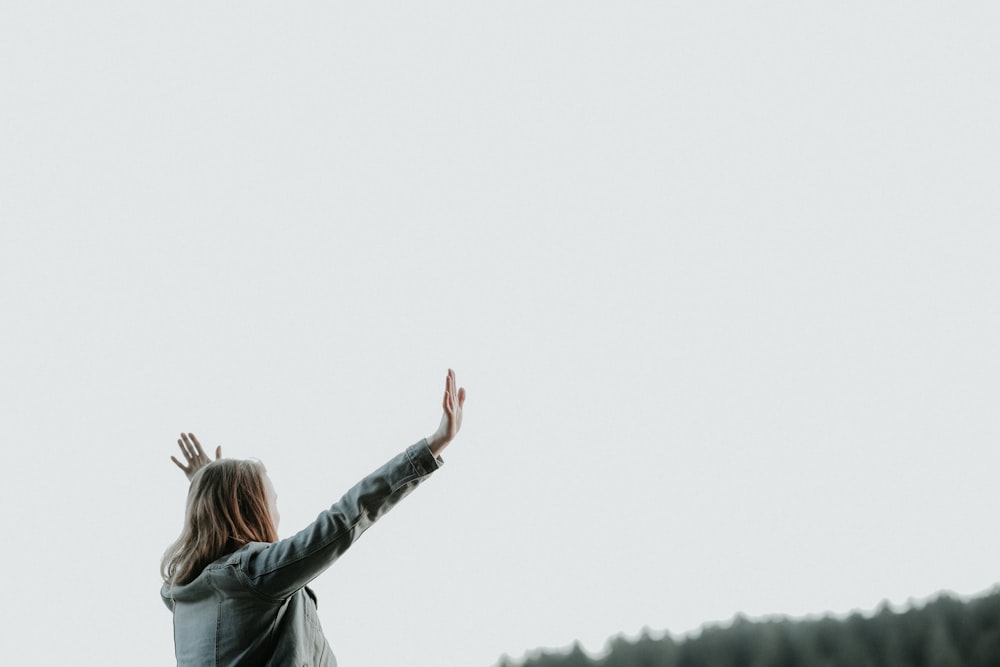 woman raising her hands