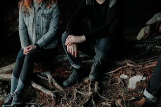 two person sitting on wood slab