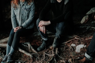 two person sitting on wood slab