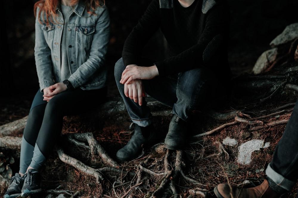 two person sitting on wood slab