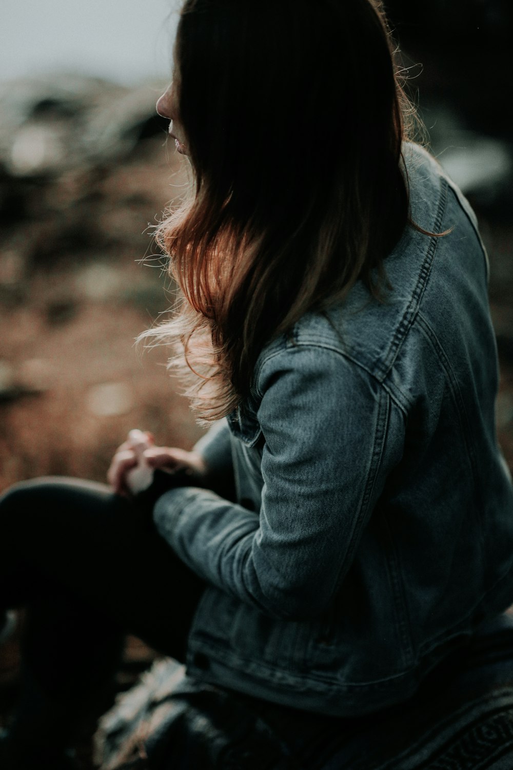 shallow focus photo of woman in blue denim jacket