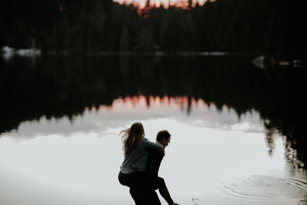 man carrying woman in his back