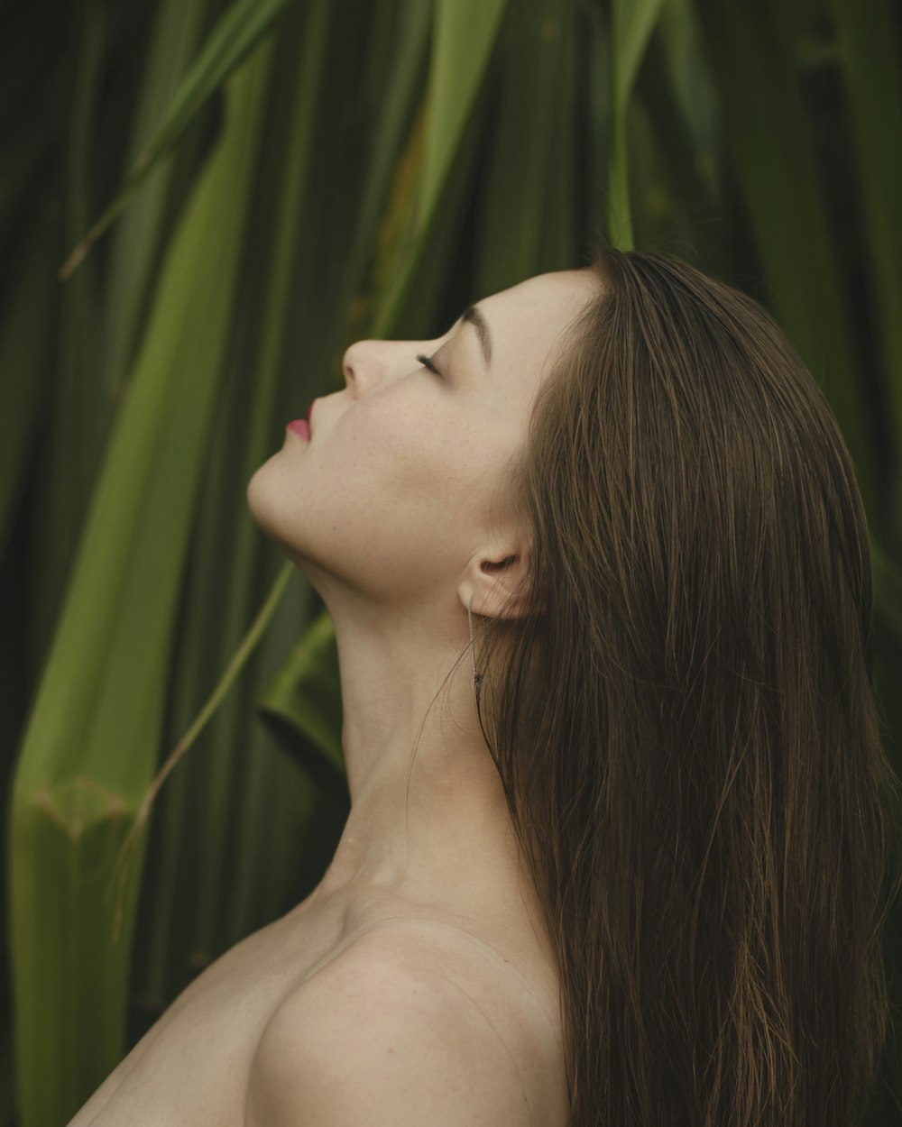 woman on front of green leaves