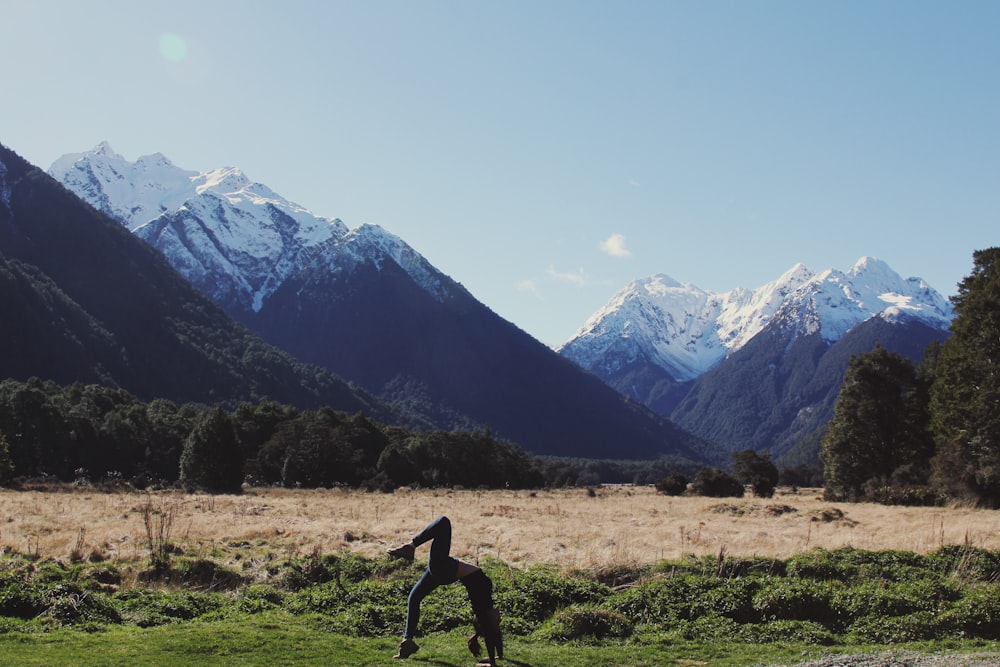 woman bending on grass field