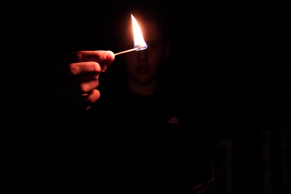 person holding lighted match