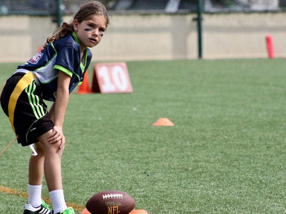 girl standing in front of NFL football