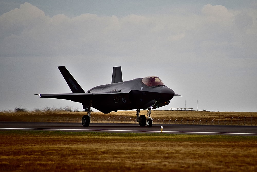 black fighter plane on road