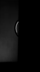 Metallic door details with chrome accents reflecting ambient warm light in a dark setting.