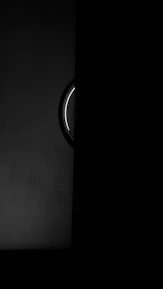 Sleek black door with subtle golden accents under soft cinematic lighting