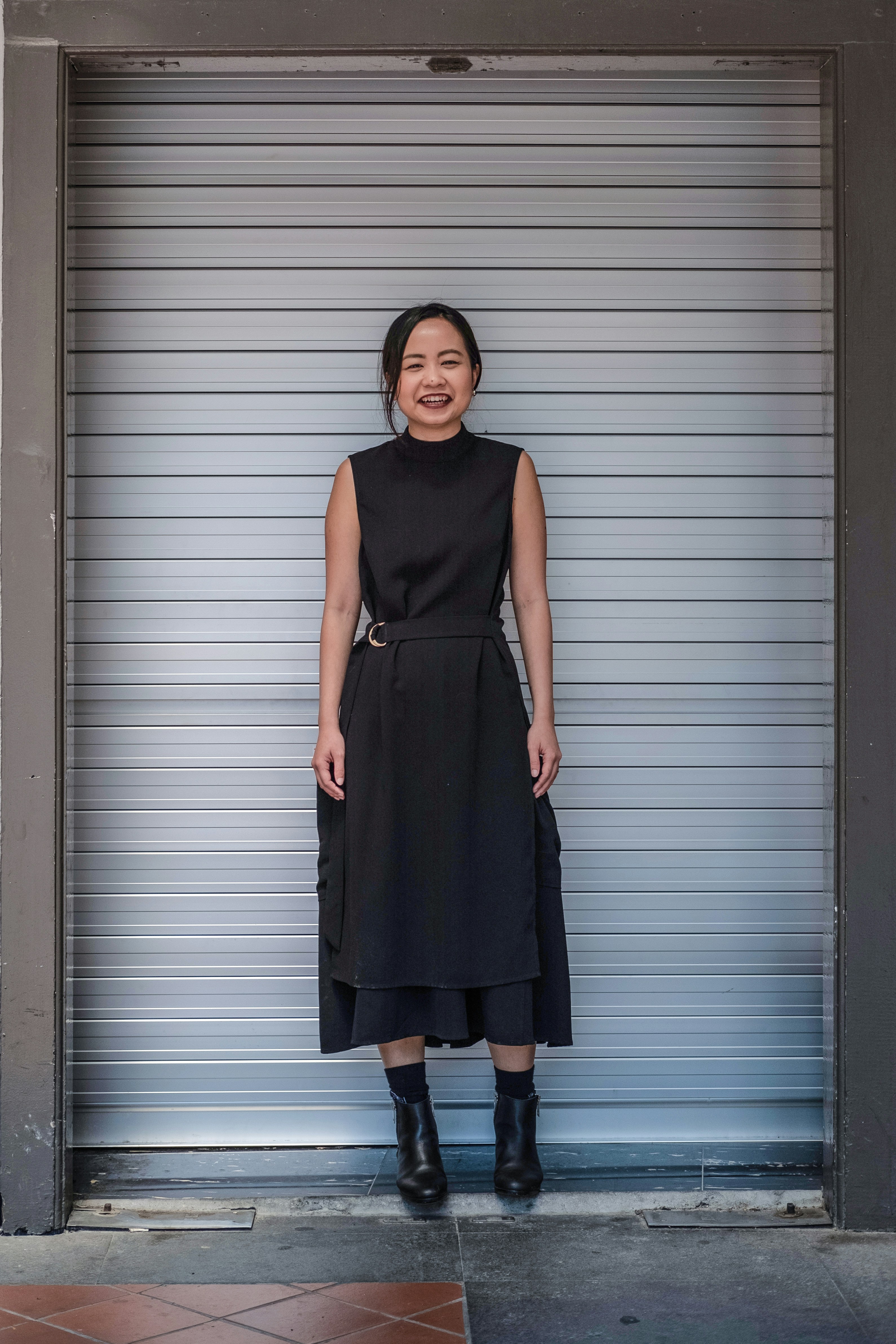 woman standing beside roller shutter