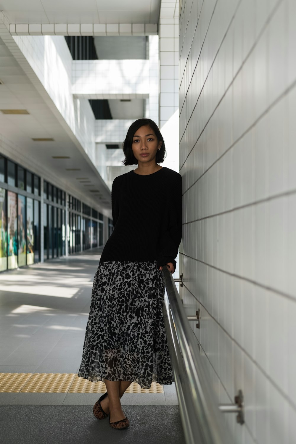 woman leaning on wall