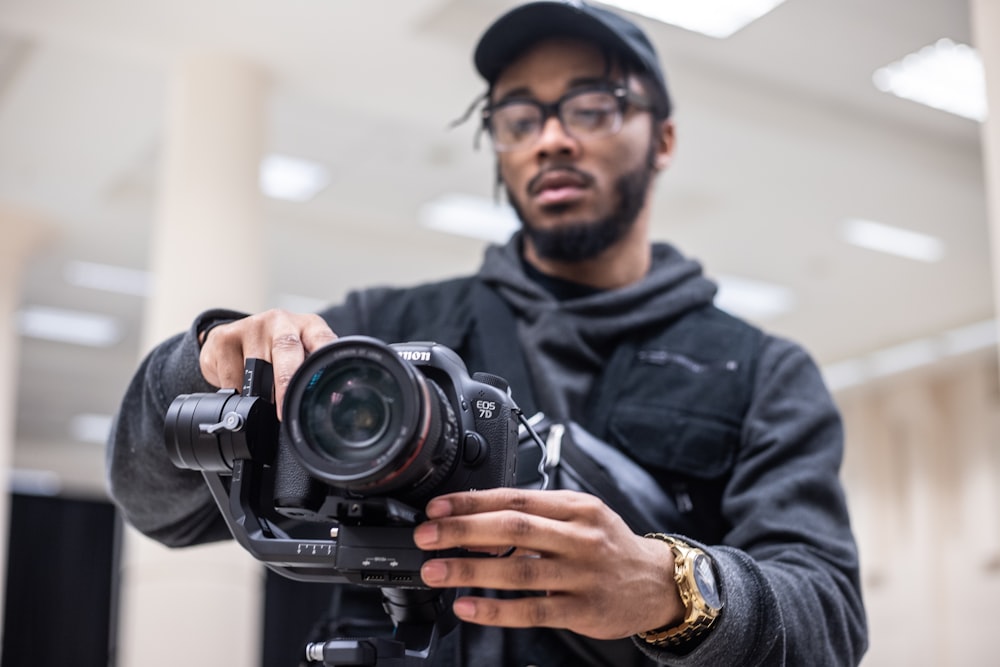 man using black Canon DSLR camera
