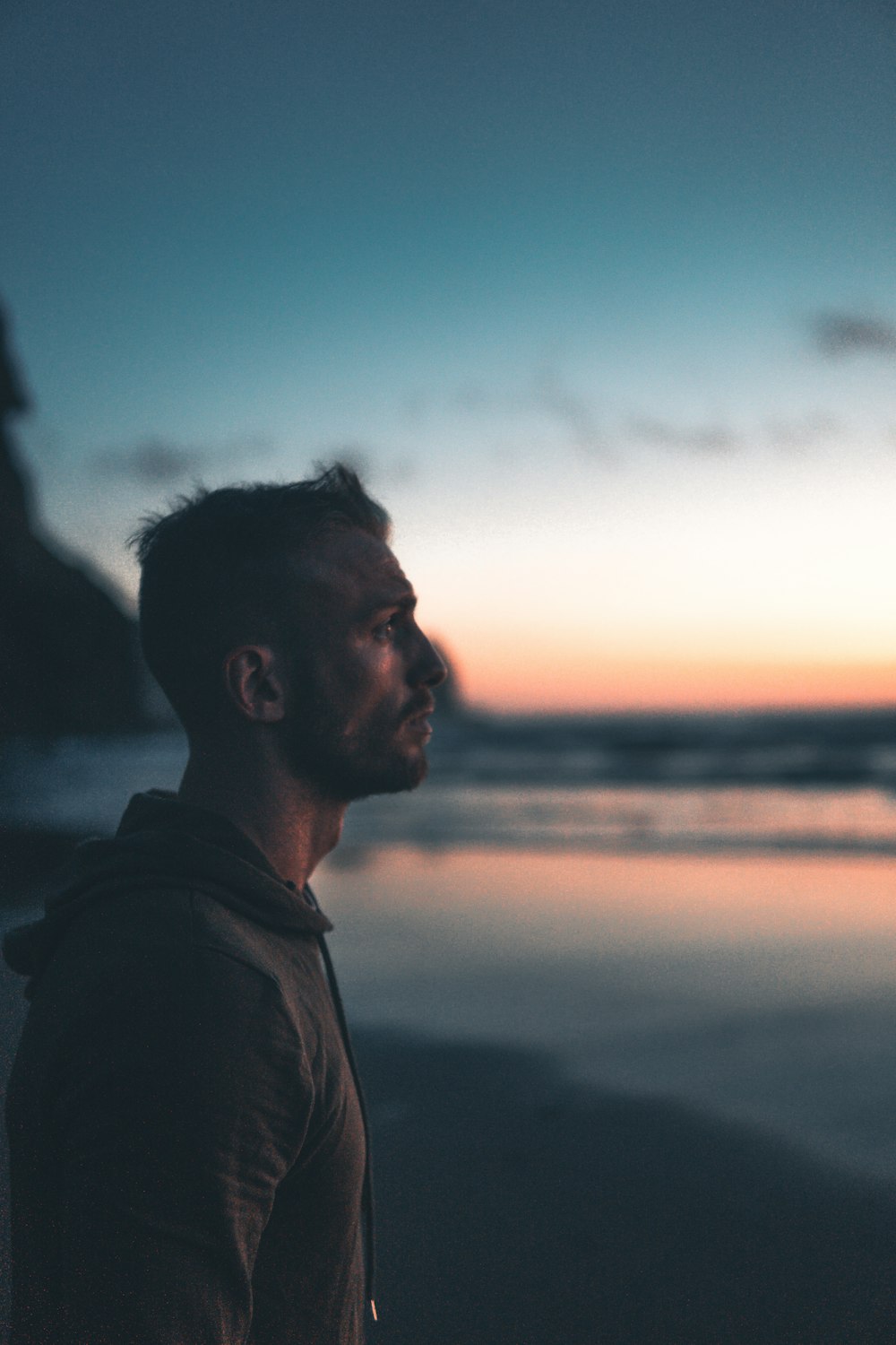 man standing near shore during daytime