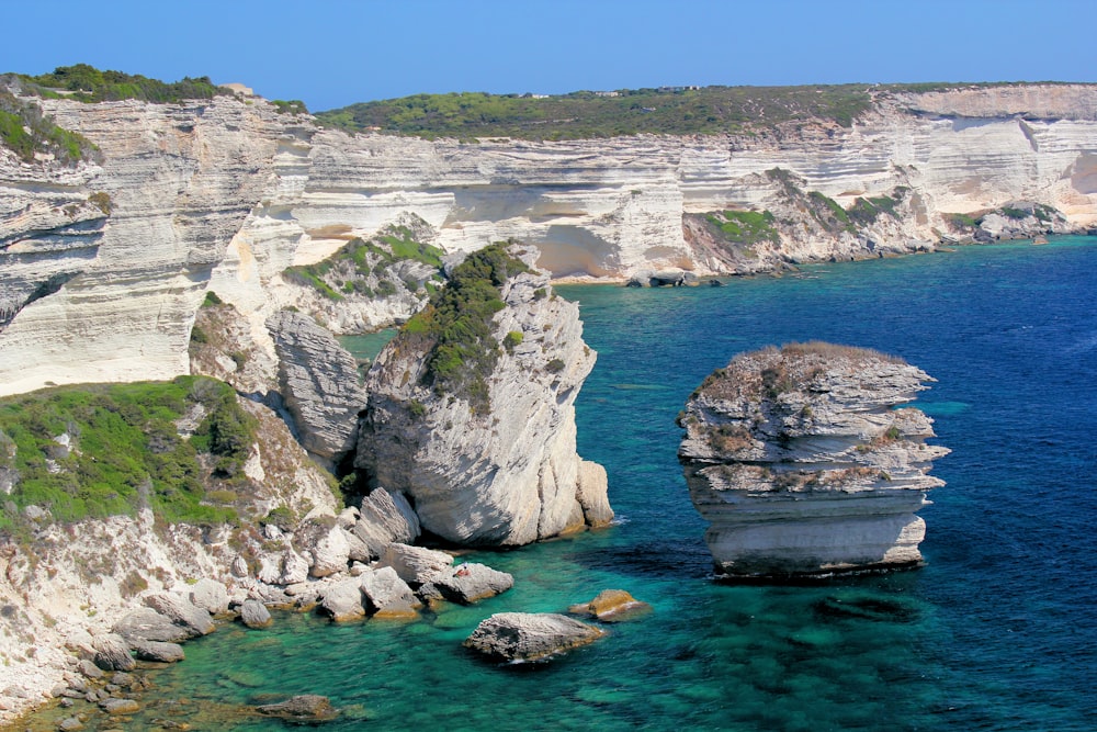 a body of water surrounded by rocky cliffs