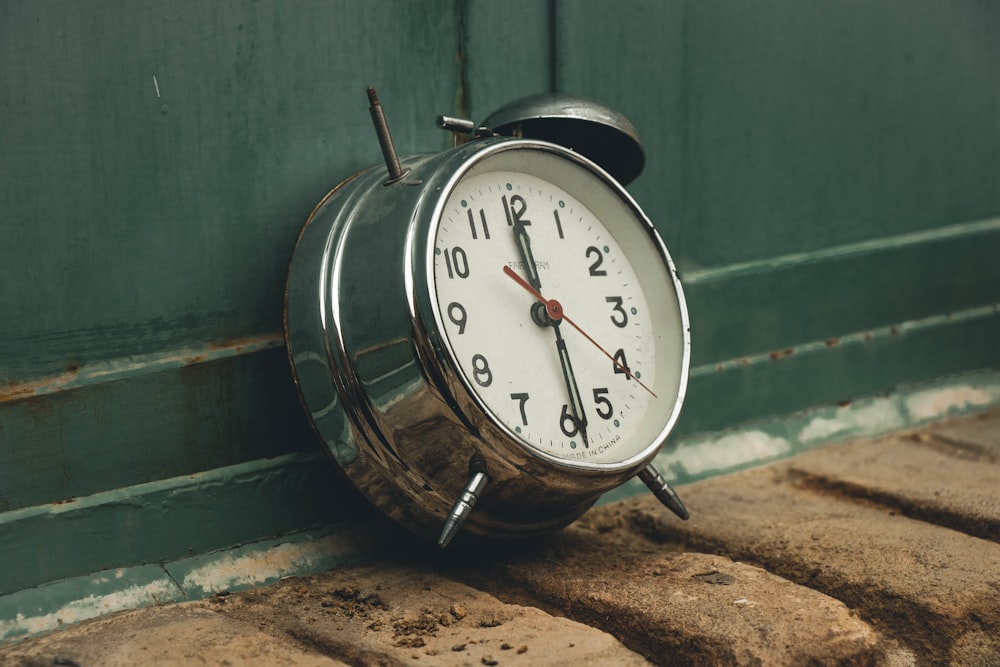 an alarm clock sitting on the side of a building