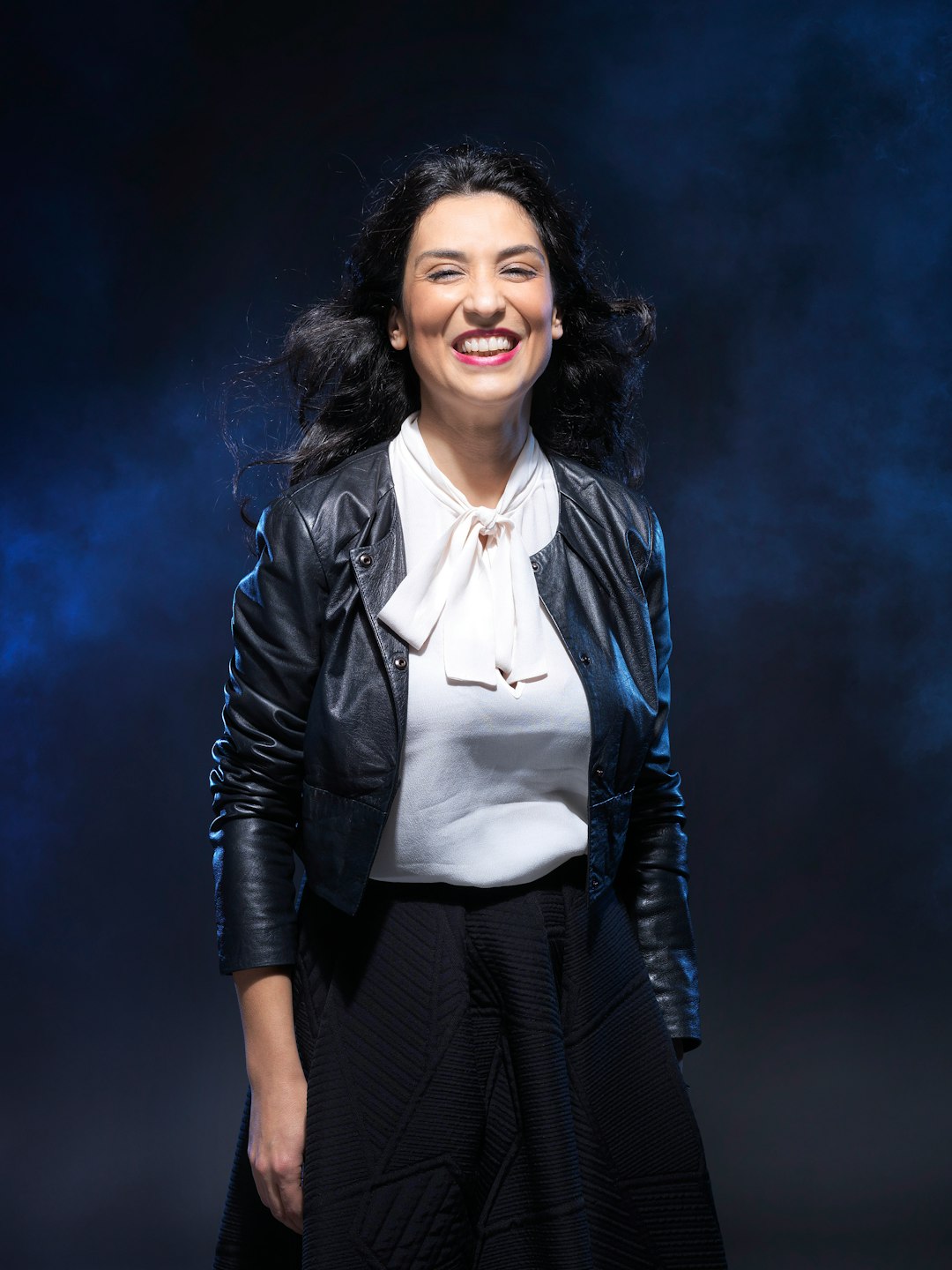 smiling woman in black leather jacket