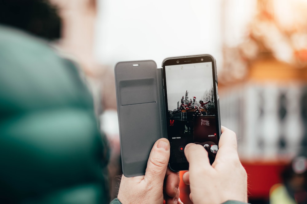 a person taking a picture with a cell phone