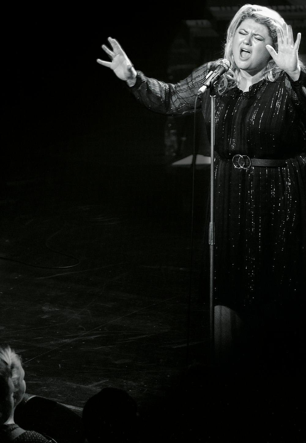 woman singing on stage