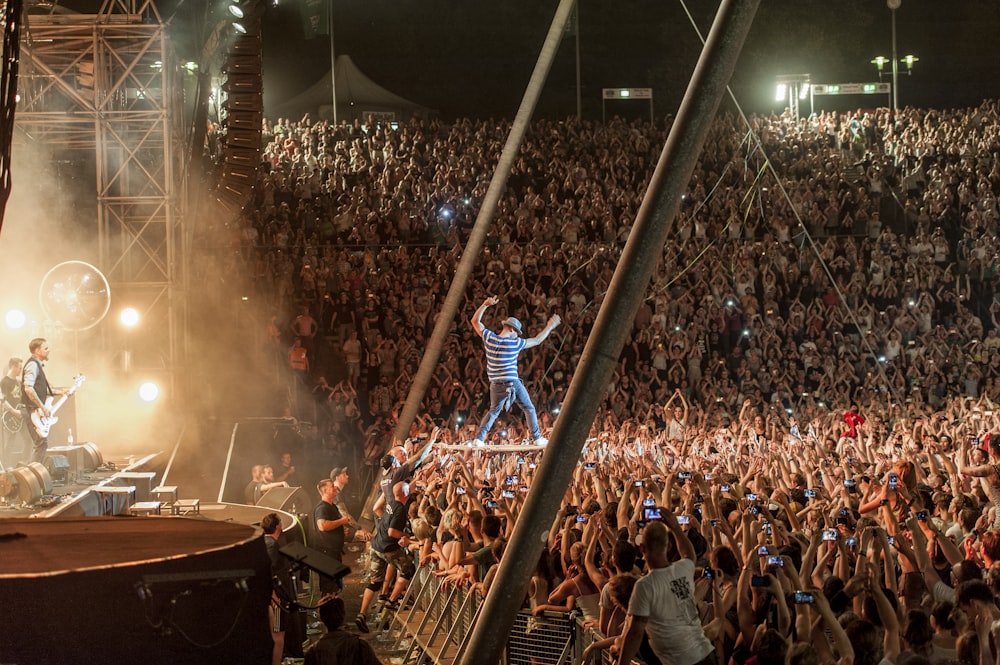 man doing stunt front of crowded people